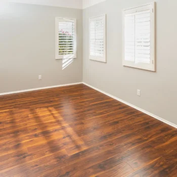 Newly Installed Brown Laminate Flooring and Baseboards in Home.